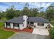 Aerial view of a single-story home featuring a well-maintained lawn and neutral exterior at 2630 S Tanner Rd, Orlando, FL 32820