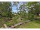 Picturesque backyard garden featuring lush greenery, mature trees, and a charming garden area, creating a serene outdoor space at 2630 S Tanner Rd, Orlando, FL 32820