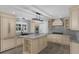 Modern kitchen with an island, stainless steel appliances, custom cabinets, and tile backsplash at 2630 S Tanner Rd, Orlando, FL 32820