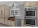 Close up of modern kitchen features like the stainless steel appliances, custom cabinets, and large sink at 2630 S Tanner Rd, Orlando, FL 32820