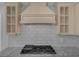 Close-up of a kitchen range hood, decorative backsplash, and countertops at 2630 S Tanner Rd, Orlando, FL 32820