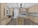 Modern kitchen with custom cabinets, an island with seating, and stainless steel appliances at 2630 S Tanner Rd, Orlando, FL 32820