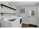 Bright laundry room features shelving, modern appliances, and exterior door at 2630 S Tanner Rd, Orlando, FL 32820