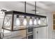 Modern, open-frame pendant light fixture with clear glass and Edison bulbs at 2630 S Tanner Rd, Orlando, FL 32820