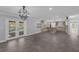 Open-concept layout featuring luxury vinyl plank flooring, modern lighting, and access to the backyard pool at 2630 S Tanner Rd, Orlando, FL 32820