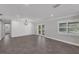 Bright living area with French doors, luxury vinyl plank flooring, and modern lighting at 2630 S Tanner Rd, Orlando, FL 32820