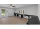 Spacious living room featuring an expansive desk, tile floors, and a ceiling fan at 2630 S Tanner Rd, Orlando, FL 32820