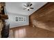 Living room features wood flooring, a wood accent wall, stone fireplace, and natural light at 2630 S Tanner Rd, Orlando, FL 32820