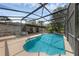 Screened-in pool area with a sparkling pool, deck space, and string lights; ideal for outdoor relaxation and entertaining at 2630 S Tanner Rd, Orlando, FL 32820