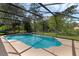 Inviting screened-in pool with lush backyard views provides a private outdoor oasis for relaxation and enjoyment at 2630 S Tanner Rd, Orlando, FL 32820