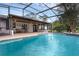Screened in pool area with a covered patio provides shade for outdoor living at 2630 S Tanner Rd, Orlando, FL 32820