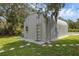 A metal quonset hut-style shed with a window and a door with glass panels at 2630 S Tanner Rd, Orlando, FL 32820