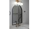 Elegant bathroom mirror above a modern sink with gold fixtures and a black frame, complemented by stylish globe lighting at 2639 Monaco Cove Cir, Orlando, FL 32825