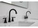 Close up of bathroom sink with black faucet and marble countertop at 2639 Monaco Cove Cir, Orlando, FL 32825