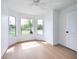 A bright primary bedroom featuring a sitting area with large windows overlooking the front yard at 2639 Monaco Cove Cir, Orlando, FL 32825