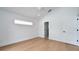 A spacious bedroom with modern lighting, wood floors and white trim at 2639 Monaco Cove Cir, Orlando, FL 32825