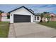 Charming single-Gathering home with a dark gray garage door and a well-maintained front yard at 2639 Monaco Cove Cir, Orlando, FL 32825