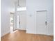 Bright foyer with wood floors, high ceilings, and a modern light fixture at 2639 Monaco Cove Cir, Orlando, FL 32825