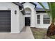 A beautiful front door entrance with arched detailing and well-manicured landscaping leads guests to this charming home at 2639 Monaco Cove Cir, Orlando, FL 32825