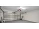 Spacious garage with white walls, gray floor, and a white sectional garage door at 2639 Monaco Cove Cir, Orlando, FL 32825