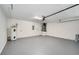 Clean and spacious garage featuring a water heater, neutral paint, and ample storage space at 2639 Monaco Cove Cir, Orlando, FL 32825