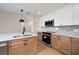 Modern kitchen boasts stainless appliances, stone counters, ample cabinetry, and pendant lighting for a gourmet cooking experience at 2639 Monaco Cove Cir, Orlando, FL 32825