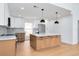 Bright kitchen featuring an island, stainless steel appliances, and modern two-tone cabinetry at 2639 Monaco Cove Cir, Orlando, FL 32825