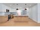 Bright kitchen featuring an island, stainless steel appliances, and modern two-tone cabinetry at 2639 Monaco Cove Cir, Orlando, FL 32825