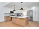 Kitchen with white cabinets, an island, and stainless steel appliances at 2639 Monaco Cove Cir, Orlando, FL 32825