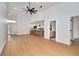 Bright open-concept living room flows into a modern kitchen, showcasing light wood floors and vaulted ceilings at 2639 Monaco Cove Cir, Orlando, FL 32825