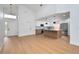 Spacious living room leads into kitchen with stainless appliances, an island with pendant lights and a large entry way at 2639 Monaco Cove Cir, Orlando, FL 32825