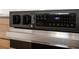 Close-up of a black stainless steel oven with a digital display and knob controls at 2639 Monaco Cove Cir, Orlando, FL 32825