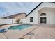 Backyard pool area and patio with a white privacy fence and lush vegetation at 2639 Monaco Cove Cir, Orlando, FL 32825