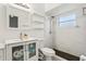 Bathroom featuring a modern vanity, toilet, open shelves, and shower with stylish black tile at 298 San Gabriel St, Winter Springs, FL 32708