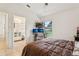 Bedroom featuring tan tile floors, and a double bed with an en-suite bathroom at 298 San Gabriel St, Winter Springs, FL 32708