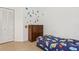 ' bedroom featuring closet space, dresser and outer-space themed wall decor over a patterned bed at 298 San Gabriel St, Winter Springs, FL 32708