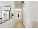 Bright hallway with tile flooring and direct view to kitchen featuring stainless steel refrigerator and granite countertop at 298 San Gabriel St, Winter Springs, FL 32708