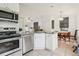 Bright kitchen boasts stainless steel appliances, granite counters, and views to the dining area at 298 San Gabriel St, Winter Springs, FL 32708