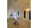 Open-concept living room featuring brick fireplace, ceiling fan, tile floors, sliding glass doors, and attached dining area at 298 San Gabriel St, Winter Springs, FL 32708