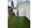 Exterior view of shed with an artificial turf lawn in a fenced backyard area at 298 San Gabriel St, Winter Springs, FL 32708