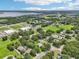 A neighborhood with tree-lined streets and a glimpse of a lake in the distance at 302 E Oakland Ave, Oakland, FL 34760