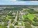 Aerial view of the property with lot lines, highlighting the home's location in a green, residential area at 302 E Oakland Ave, Oakland, FL 34760