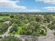 Aerial shot captures the property nestled within a lush, green landscape, offering privacy and tranquility at 302 E Oakland Ave, Oakland, FL 34760