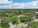 Overhead shot highlights the property amid verdant trees and landscaping, providing a sense of peaceful seclusion at 302 E Oakland Ave, Oakland, FL 34760