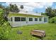 The backyard boasts mature trees and ample space for outdoor activities at 302 E Oakland Ave, Oakland, FL 34760