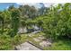 Overgrown backyard shows potential with climbing vines and a vintage block wall at 302 E Oakland Ave, Oakland, FL 34760