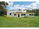 Charming single-story home with a well-maintained lawn and mature trees at 302 E Oakland Ave, Oakland, FL 34760