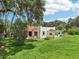 Charming Spanish-style home boasting a red tile roof and lush green lawn at 302 E Oakland Ave, Oakland, FL 34760