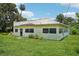 Exterior view of a bright single-story home with large front yard at 302 E Oakland Ave, Oakland, FL 34760