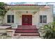 Exterior shot of house with red tile roof, front porch with red flooring and columns at 302 E Oakland Ave, Oakland, FL 34760